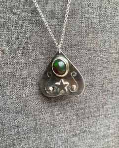 This is a one off hand made piece featuring a black, ethically sourced Ethiopian opal as the Planchette 'eye'. Photos do not do this opal justice, it has beautiful flashes of green, blue, red, yellow, and it has a honeycomb like pattern. 